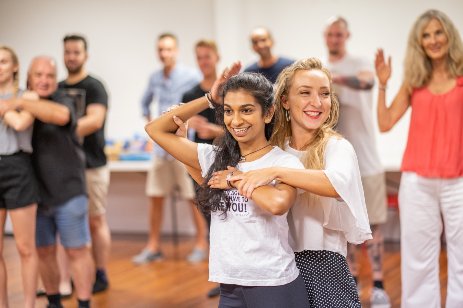 Students learning body movement and styling in class